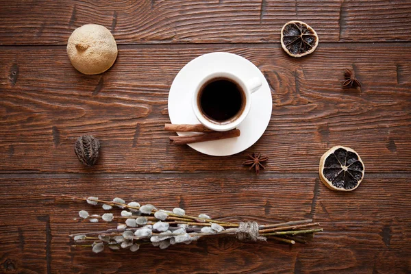 Coffee cup and willow branches, dry lemon, cinnamon. — Stock Photo, Image
