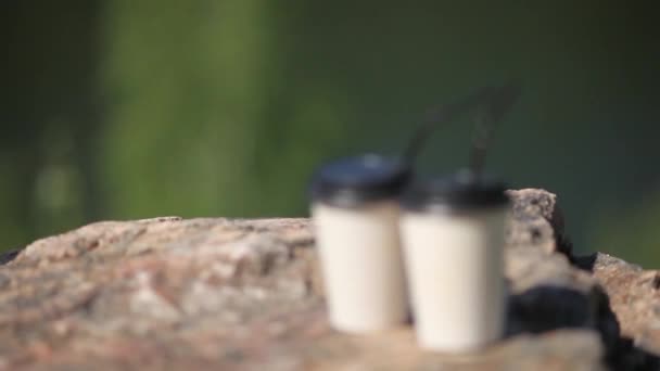 Papírové šálky kávy na přírodním jitřním pozadí — Stock video