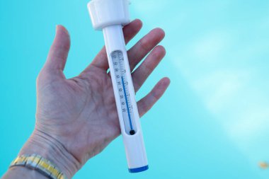 Bir termometre ile yüzme havuzu su sıcaklığını kontrol