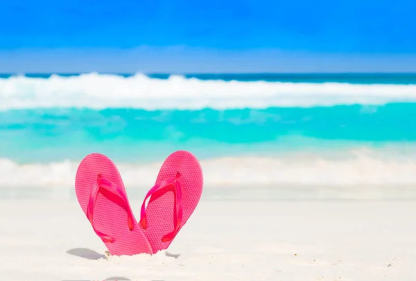 Pink flip flops over a tropical sea resort background — Stock Photo, Image