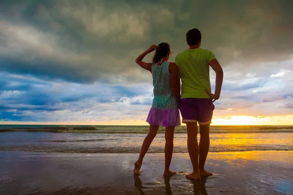 Sunset silueta de pareja joven enamorada abrazándose en la playa —  Fotos de Stock