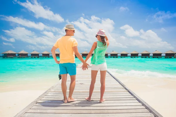 Young happy family having fun on tropical beach. — Stock Photo, Image