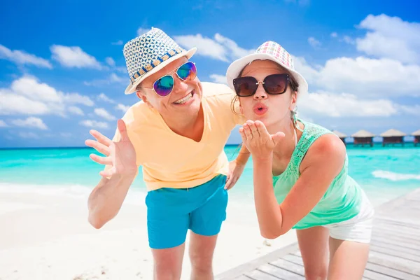 Young happy family having fun on tropical beach. — Stock Photo, Image