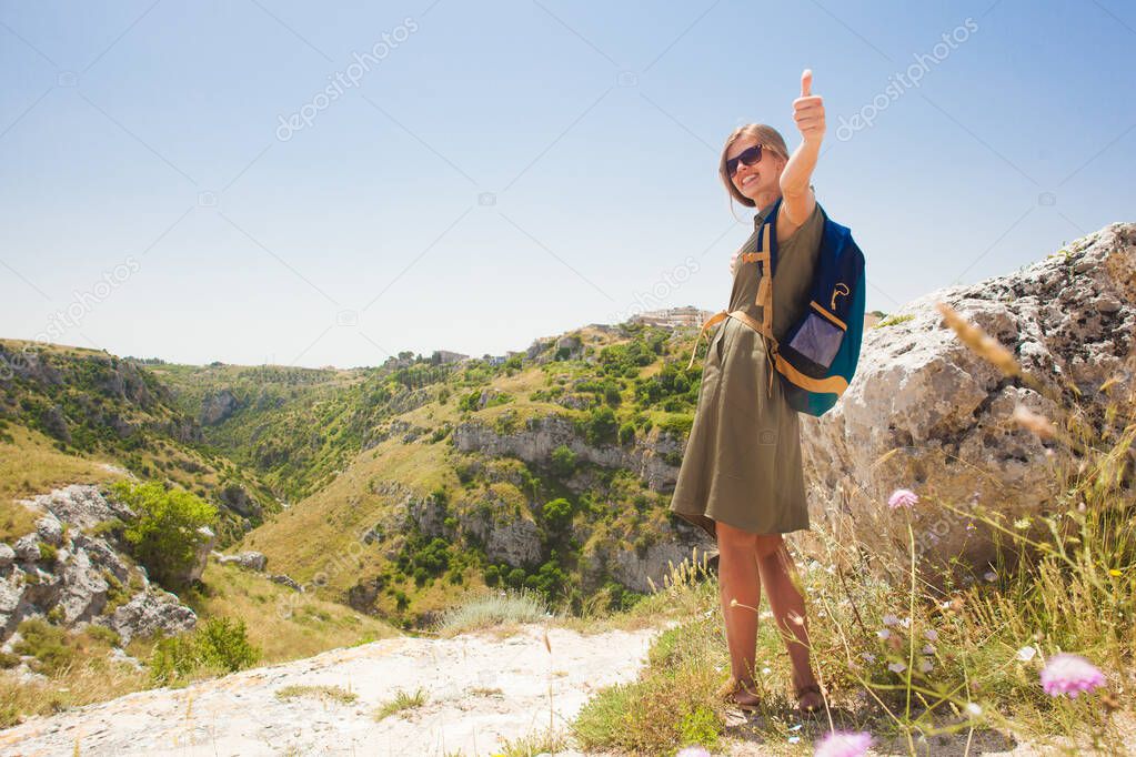 Pretty woman with backpack.hiking near Matera, Basilicata region. Italy