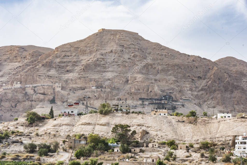 Close-up of the Mount of Temptation from Jericho city plagued by constructions and millenary excavations. Jordan Valley West Bank Palestinian