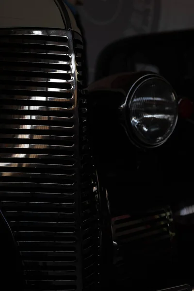 The headlight of an antique, rarity, vintage black car.