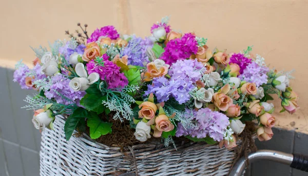 Flowers in a basket on the street.