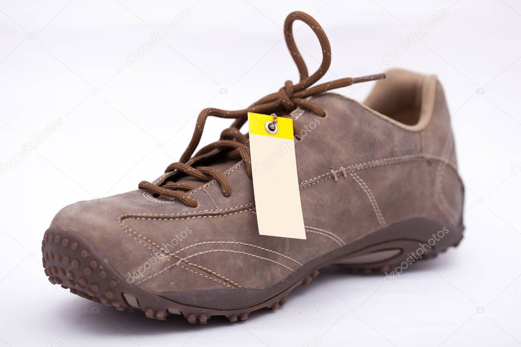 Beige shoes with a label on a white background