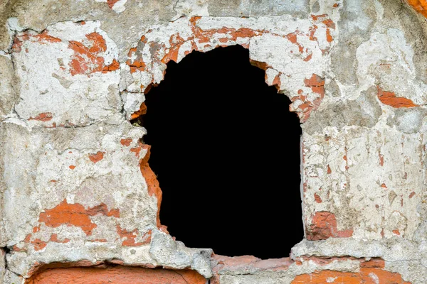 Hole in the wall of red brick.