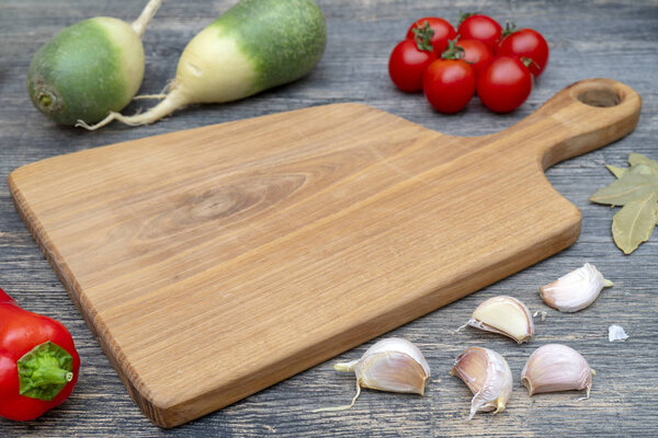 Oak cutting board on the kitchen table.