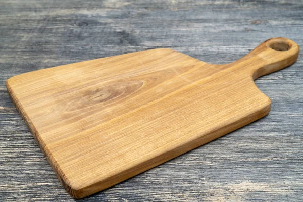 Oak cutting board on the kitchen table.