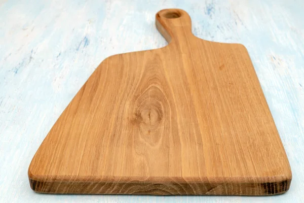 Wooden oak cutting board. Kitchenware. Copy space