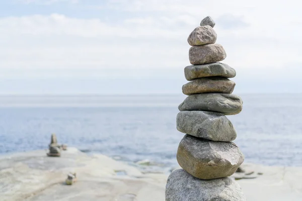 Stacked Rocks balancing, stacking with precision. Stone towers on the shore