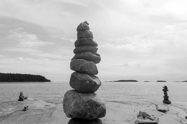 Stacked Rocks balancing, stacking with precision. Stone towers on the shore