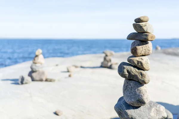 Stacked Rocks balancing, stacking with precision. Stone towers on the shore