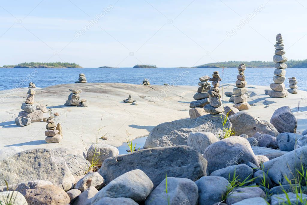 Stacked Rocks balancing, stacking with precision. Stone towers on the shore