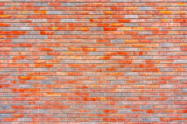 Colorful brick wall texture. Loft interior design.  Orange and grey paint of facade.