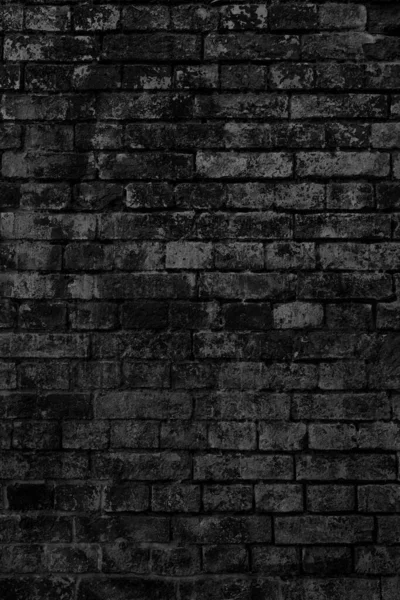 The background of the old black brick wall for design interior and  various scenes or as a background for video interviews.