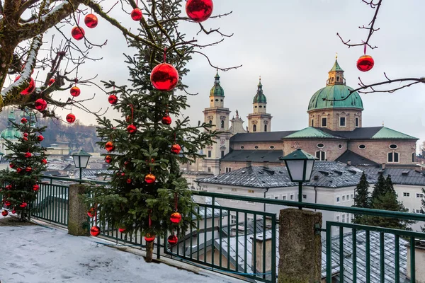 Hermosa vista de la histórica ciudad de Salzburgo con la famosa Catedral de Salzburgo en invierno, Austria.Árboles de Navidad con bolas de Navidad rojas en el fondo del invierno Salzburgo . — Foto de Stock
