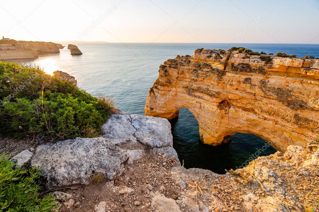Algarve, Portugal, Praia da Marinha at sunrise. Heart shaped rock
