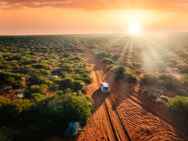 Australia, red sand unpaved road and 4x4 at sunset, freedom outback – stockfoto