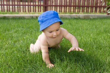 Küçük bir çocuk havuzda banyo yapıyor, yazın şişme çocukların şişme havuzunda.