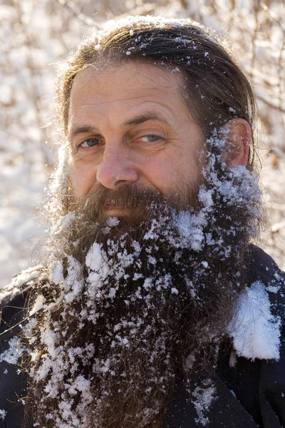 A man with a beard in the snow