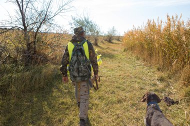 Male hunter with shotgun hunting outdoors