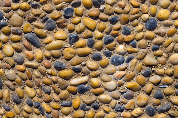 Background texture of sand with stones and pebbles