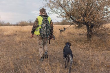 Male hunter with rifle hunting outdoors