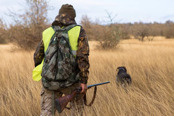 Male hunter with rifle hunting outdoors