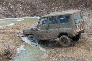 SUV car riding dirty road outdoors