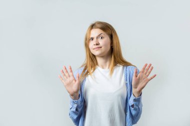 Gri bir arka plan üzerinde kızıl saçlı bir kızın duygusal portresi, fırtınalı duygular, iş kavramı.