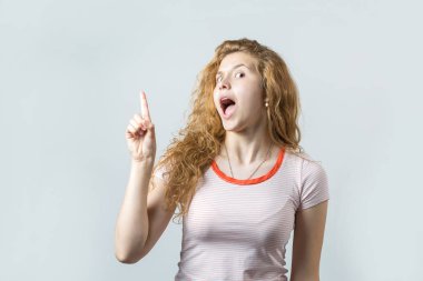 beautiful young caucasian woman having new idea on white background