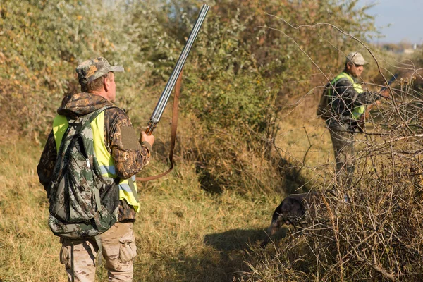 hunter with a rifle and a shotgun