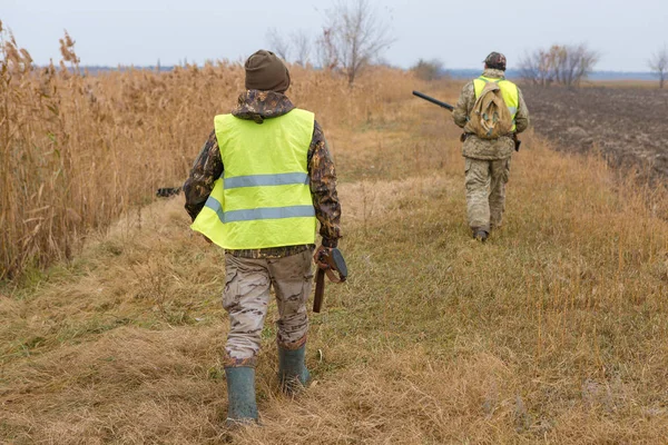 hunter with a rifle and a gun in the forest