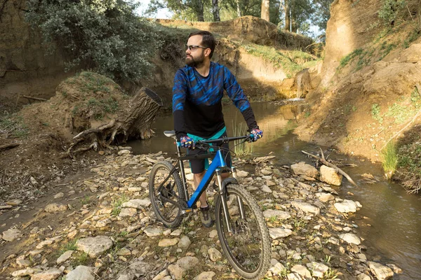 young man riding bicycle in forest