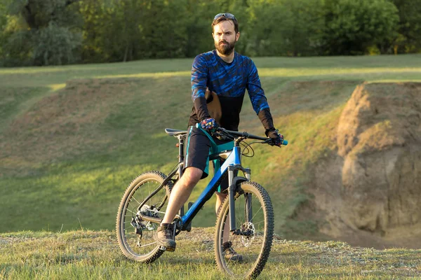 young man riding bicycle in the forest