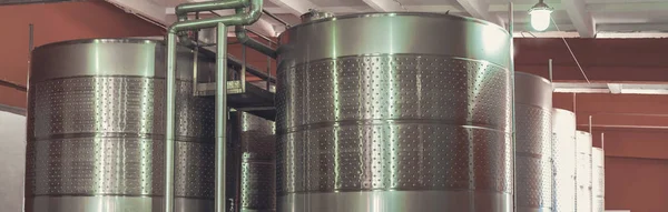 metal tanks with steel barrels and red wine