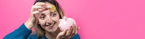 Menina Coloca Banco Porquinho Bitcoin Young Física Sobre Fundo Rosa — Fotografia de Stock