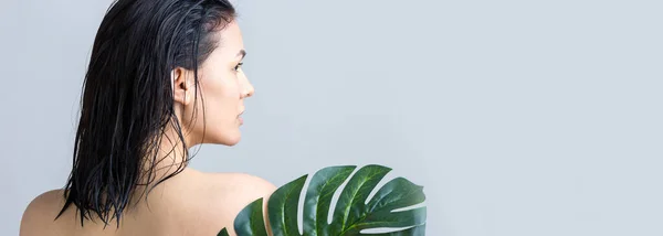 Beauty Woman with natural green palm leaf portrait. Fashion, beauty, make-up, cosmetics.