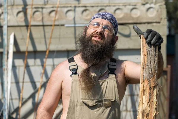 Middle Aged Bearded Man Bandana Cuts Logs Brutal Overalls Does — Stock Photo, Image