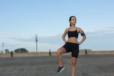 Genç çekici kadın dışarıda egzersiz yapıyor..