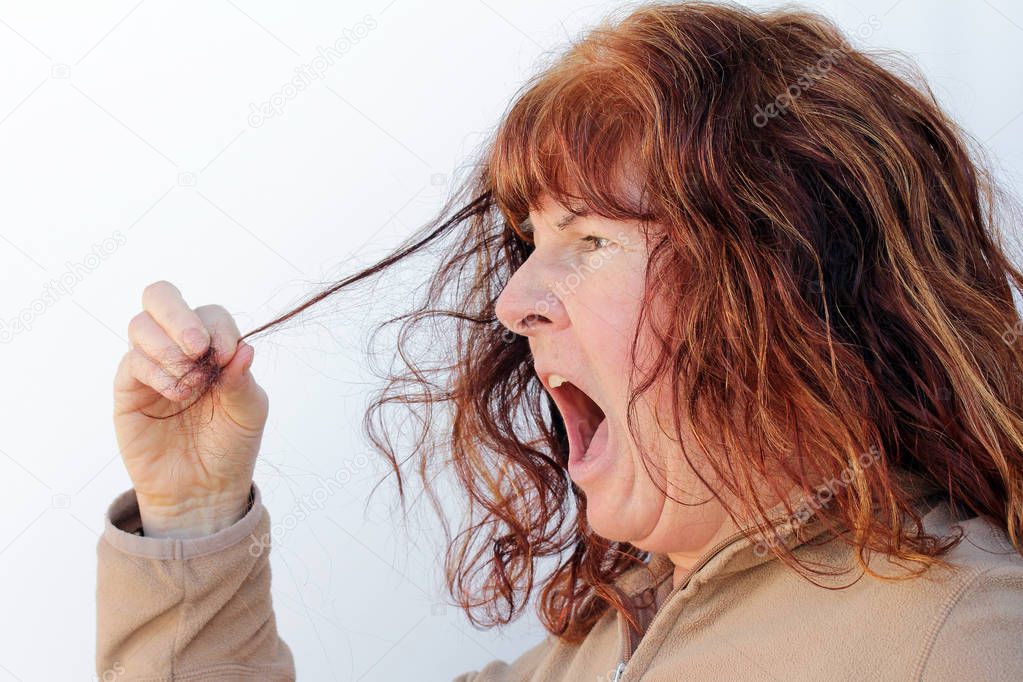 An elderly woman discovers hair loss. A woman is horrified at her hair loss