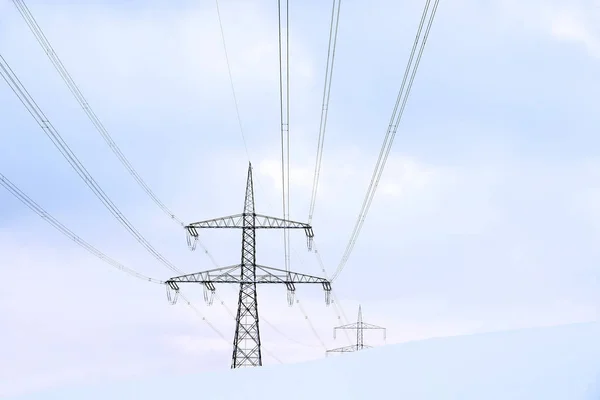 An overhead line mast for power supply in winter in the snow