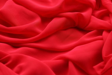 Canlı kırmızı bir kumaşın yumuşak bir görüntüsü.