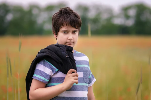 Portrait of teenager boy in field — Stock Photo, Image