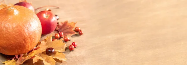 Outono, folhas de outono, abóbora e maçãs em uma mesa de madeira atrás — Fotografia de Stock