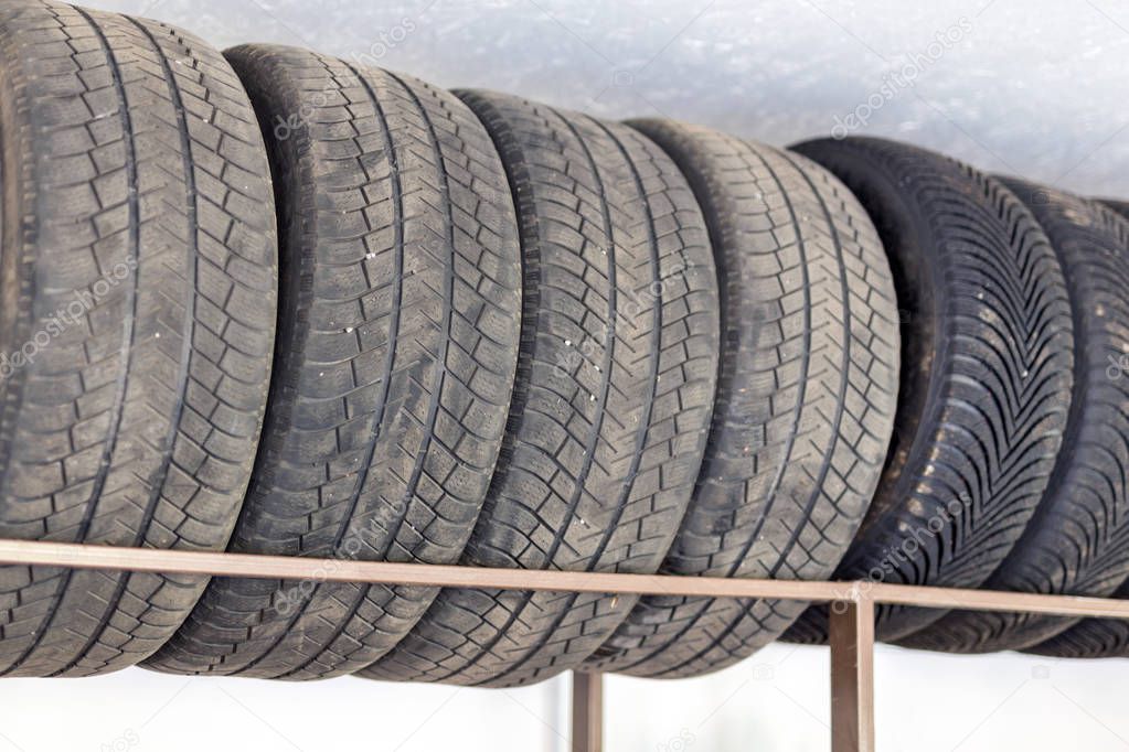 Tire seasonal storage. Set of car wheels on special shelf at home garage for seasonal replacement