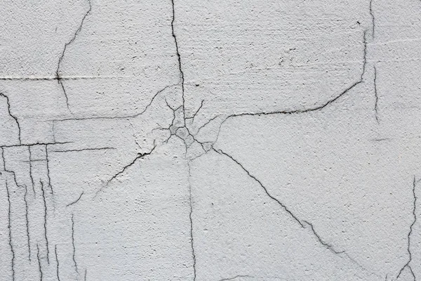 Texture of white dirty cracked wall. Small straight cracks. Direct fracture on painted surface. Cells fissure.